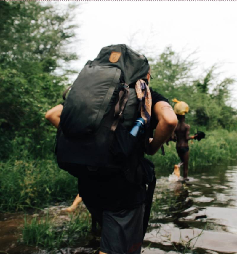 A Mission One Eleven pioneer missionary carrying a backpack